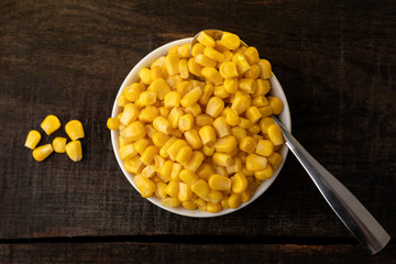 White plate on rustic table with vegetables.