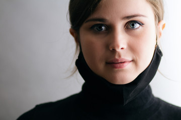 face portrait of a young woman with a black mask under her chin, girl took off the mask, life is...