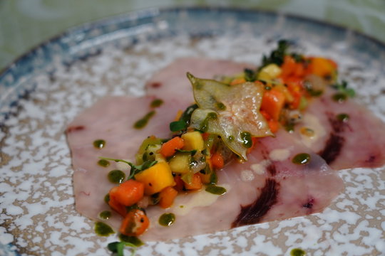 swordfish carpaccio with fruit salad. Italian food Smoked Swordfish Carpaccio.
