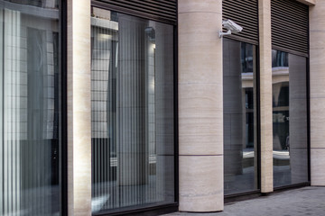 Office entrance in the building with glass doors and video camera 