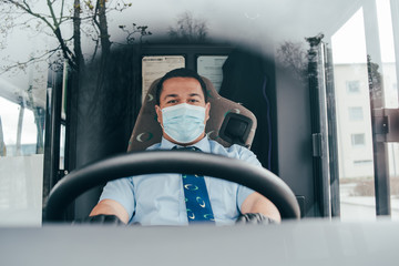 young hispanic man bus driver  in a protective mask and black gloves.