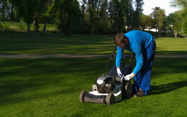 The worker prepares a mower for mowing image