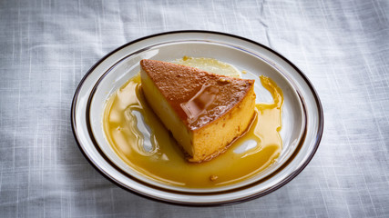 a slice of caramel flan on a plate