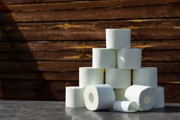 wooden background in retro style on it lined with pyrimide toilet paper