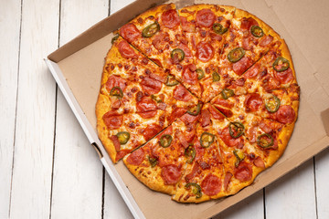 Mexican pizza with jalapeno pepper and bacon on white background