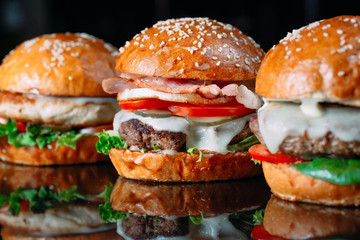 Juicy beef Burgers on a black background.