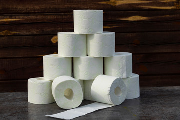 wooden background in retro style on it lined with pyrimide toilet paper