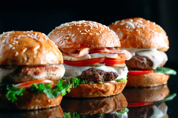 Juicy beef Burgers on a black background.