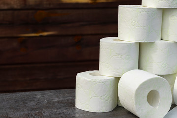 wooden background in retro style on it lined with pyrimide toilet paper