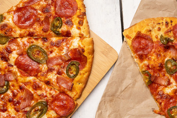 Mexican pizza with jalapeno pepper and bacon on white background