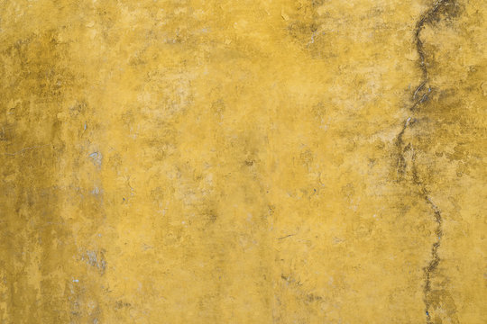 Yellow grunge cement painted wall. Textured background