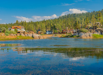 Fototapeta premium Cabins reflect into the Back bay of Boulder Bay, Big Bear Lake, California