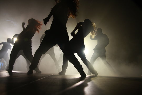 Silhouette Dancers Performing On Stage