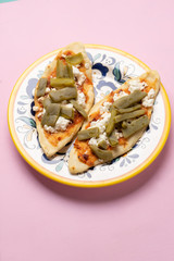 Mexican tlacoyos with nopal cactus and cheese on pink background