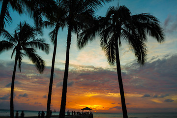 Fototapeta na wymiar Crowds Gather to Watch Sunset on Kapahula Pier and Waikiki Bay, Waikiki, Oahu, Hawaii, USA