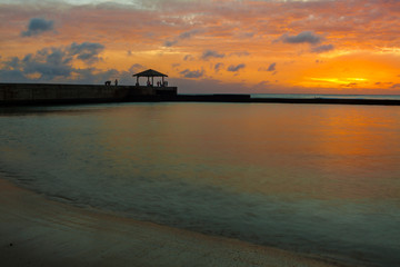 Fototapeta na wymiar Sunset on Kapahula Pier and Waikiki Bay, Waikiki, Oahu, Hawaii, USA