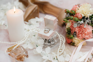Wedding rings and other accessories close-up during the bride's gathering. Wedding