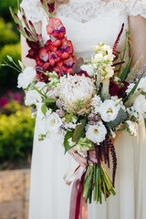 Beautiful and sophisticated wedding bouquet close-up holds the bride in her hands. Wedding bouquet