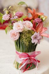 A beautiful stylish bouquet stands on the table close-up