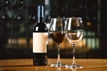 Bottles and glasses with wine on the table. Wine drinking culture concept. Apperetes and survivors. Copy space, dark background