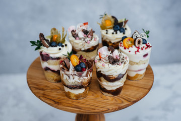 Set of beautiful delicious trifl close - up on the background. Dessert and sweets