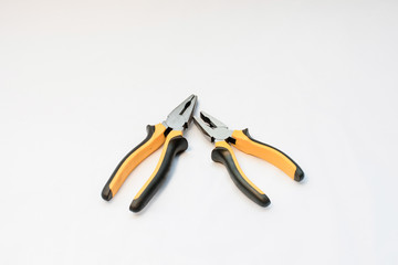 Obraz premium A black and yellow hand pliers copy spase on white