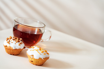 Dessert tea with Muffins on light table. Close up, Copy space.
