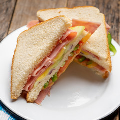 Ham sandwich with cheese on wooden background