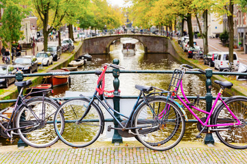Fototapeta na wymiar bicycles leaning at a bridge railing in Amsterdam, Netherlands