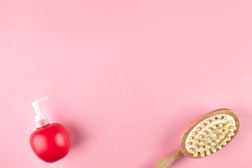 Natural Sisal washcloths, eco-friendly massage anti-cellulite brush, liquid soap in a red bottle with a dispenser, on a pink background, top view