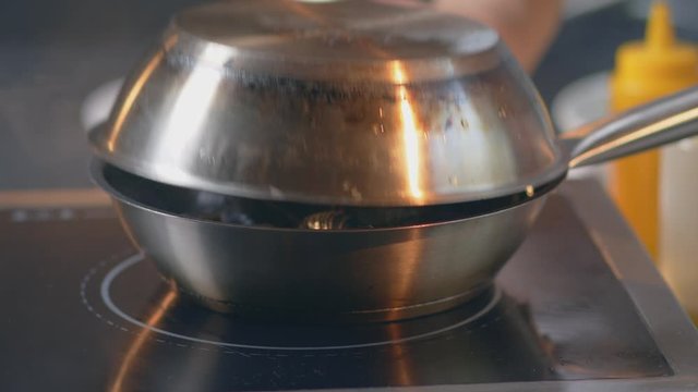 cook fries mussels in a fish restaurant
chef toassing mussel pan. Hissing mussels in frying pan
steamed seafood in a pan
close-up shot 4.6K