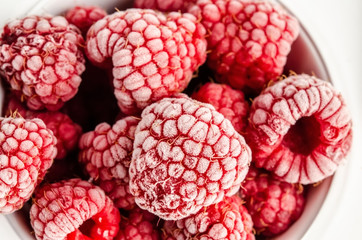 Frozen berries and raspberries on a white background. Top view, season concept, season.