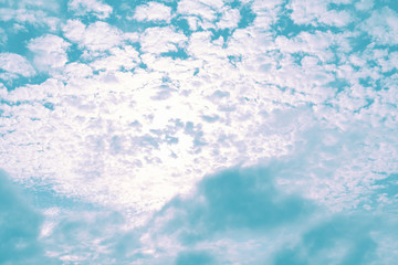 Blue sky with white clouds that is backlit by the sun. Concept landscape, background.
