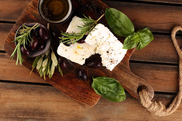 Greek cheese feta with rosemary and olives. Healthy ingredient for cooking salad. Chopped Goat feta...