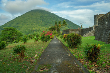 Amazing scene of Gunung Api volcano shot from vibrant beautiful gardens next to fort Belgica in Banda Neira island