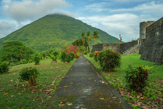 Amazing scene of Gunung Api volcano shot from vibrant beautiful gardens next to fort Belgica in Banda Neira island