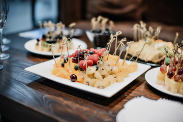 catering cheese set decorated with cream and berries on a plate