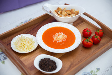 Red lentil soup . Spaghetti white plate . Dry bread and pepper . Red tomatoes . Tomato Soup wooden tray .
