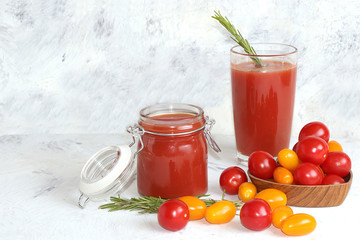 Tomato juice, sauce, pasta and ingredients on a concrete table. The concept of detox diet and weight loss, natural nutrition, healthy and natural foods. Summer drinks, vitamins C