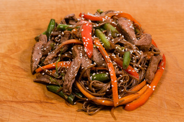 japan pasta noodles with vegetables and meat on wooden plate
