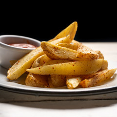 French fries with ketchup sauce on white background
