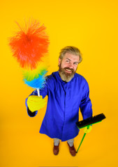 Cleaning equipment. Cleaning. Professional cleaning. Clean up. Clearing tools. Bearded man with dust brush. House cleaning. In full height. Broom. Dust brush. Household. Housekeeping.