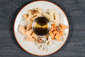 cheese set with honey on grey served table. traditional dish menu served in a restaurant. top view