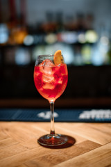red alcohol cocktail on dark bar