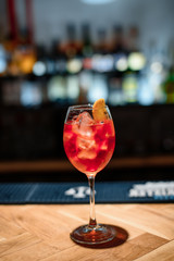 red alcohol cocktail on dark bar