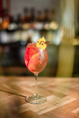 orange alcohol cocktail on dark bar