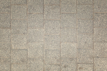 Fototapeta premium Toned photo of stone paving slabs. Dirty gray background for sites and layouts