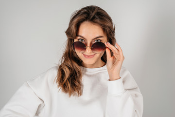 Young woman in sunglasses, isolated on white background