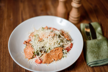 fresh caesar chiken salad on wooden table. photo for menu