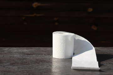 wooden background in retro style on it lined with pyrimide toilet paper